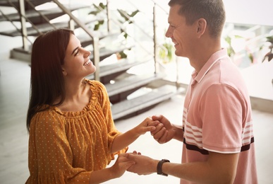 Man and woman having conversation in hall