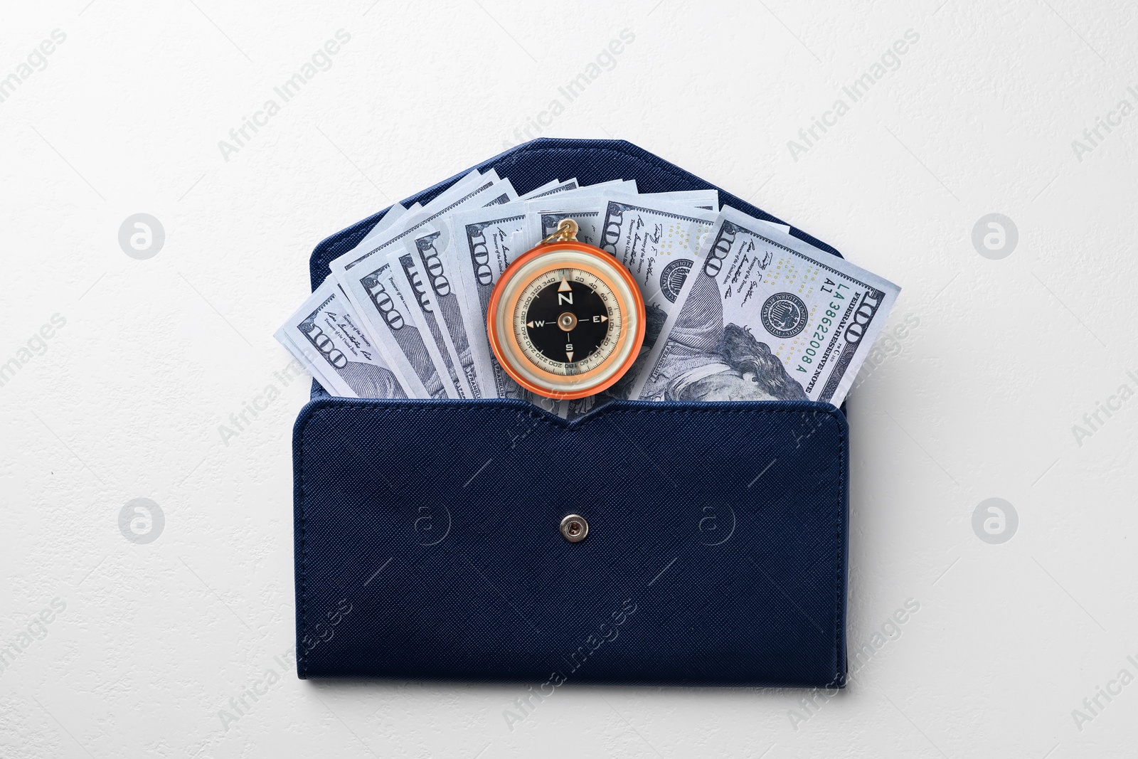 Image of Exchange rate. Wallet with money (dollar banknotes) and compass on white background, top view