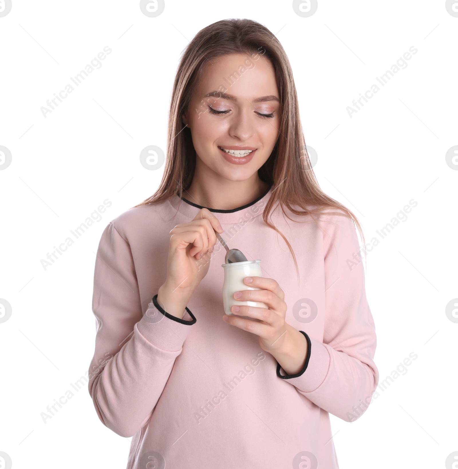 Photo of Young attractive woman with tasty yogurt on white background
