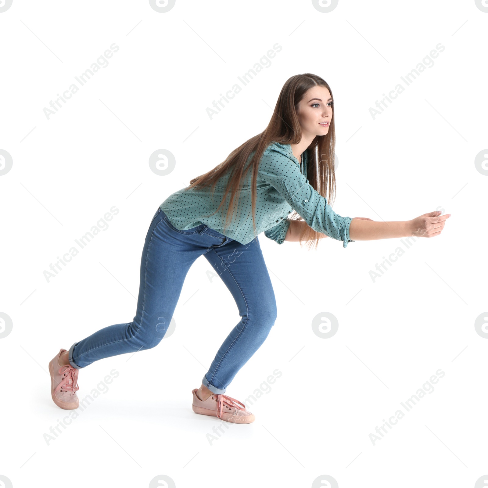 Photo of Young woman attracted to magnet on white background