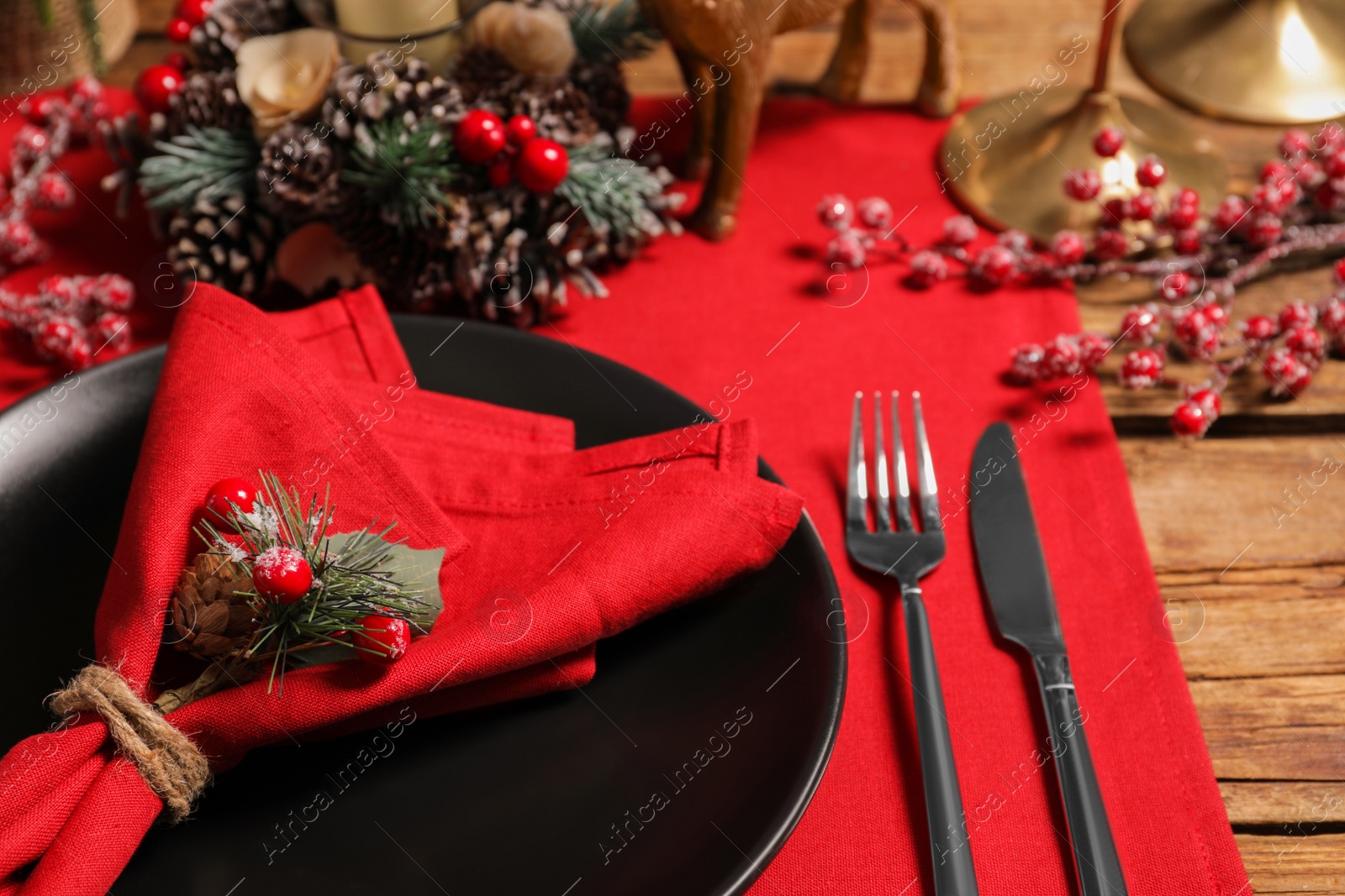 Photo of Festive place setting with beautiful dishware, cutlery and decor for Christmas dinner on wooden table