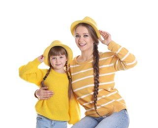 Happy woman and daughter in stylish clothes on white background