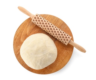 Photo of Wooden board with raw wheat dough and rolling pin on white background, top view