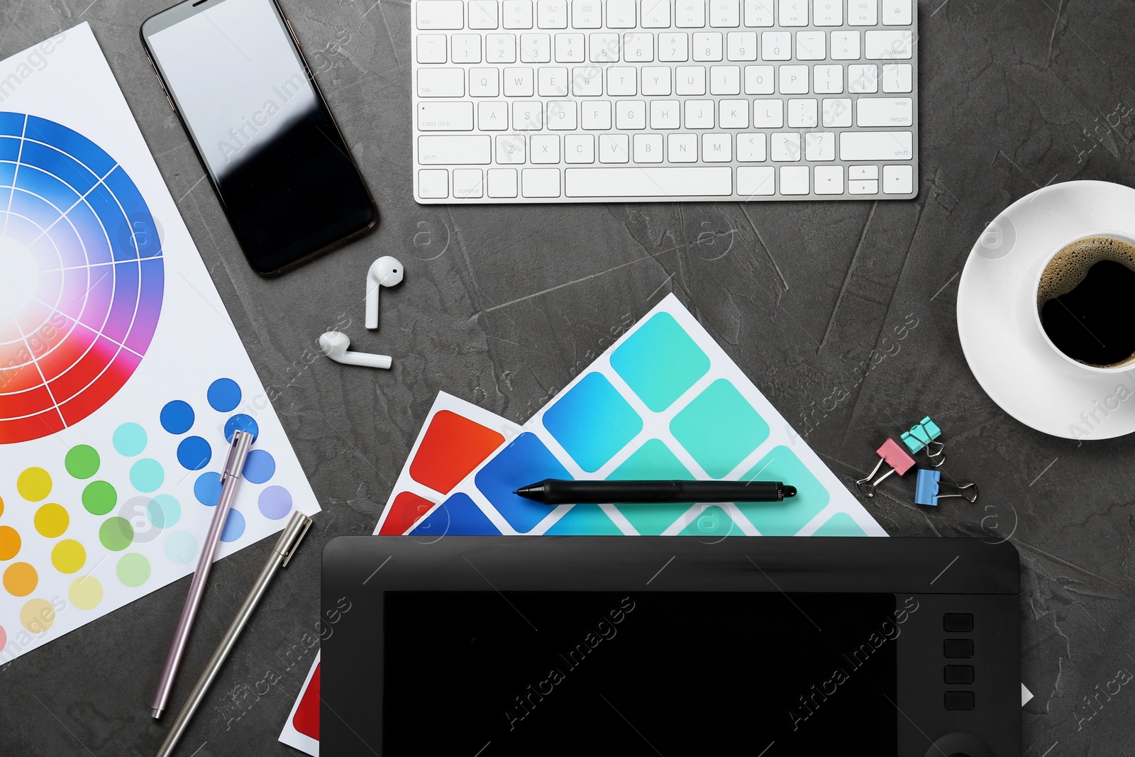 Photo of Flat lay composition with digital devices and color palettes on grey background. Graphic designer's workplace