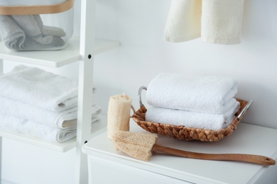 Photo of Clean towels and sponges on table indoors