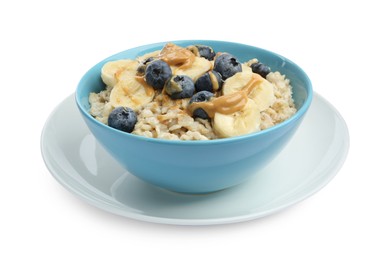 Tasty oatmeal with banana, blueberries and peanut butter in bowl isolated on white