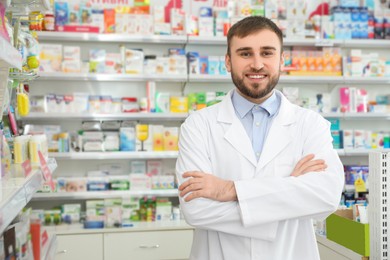 Photo of Portrait of professional pharmacist in modern drugstore. Space for text