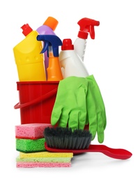 Photo of Bucket with different cleaning products and tools on white background