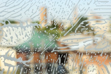Photo of Glass covered with suds as background, view from inside