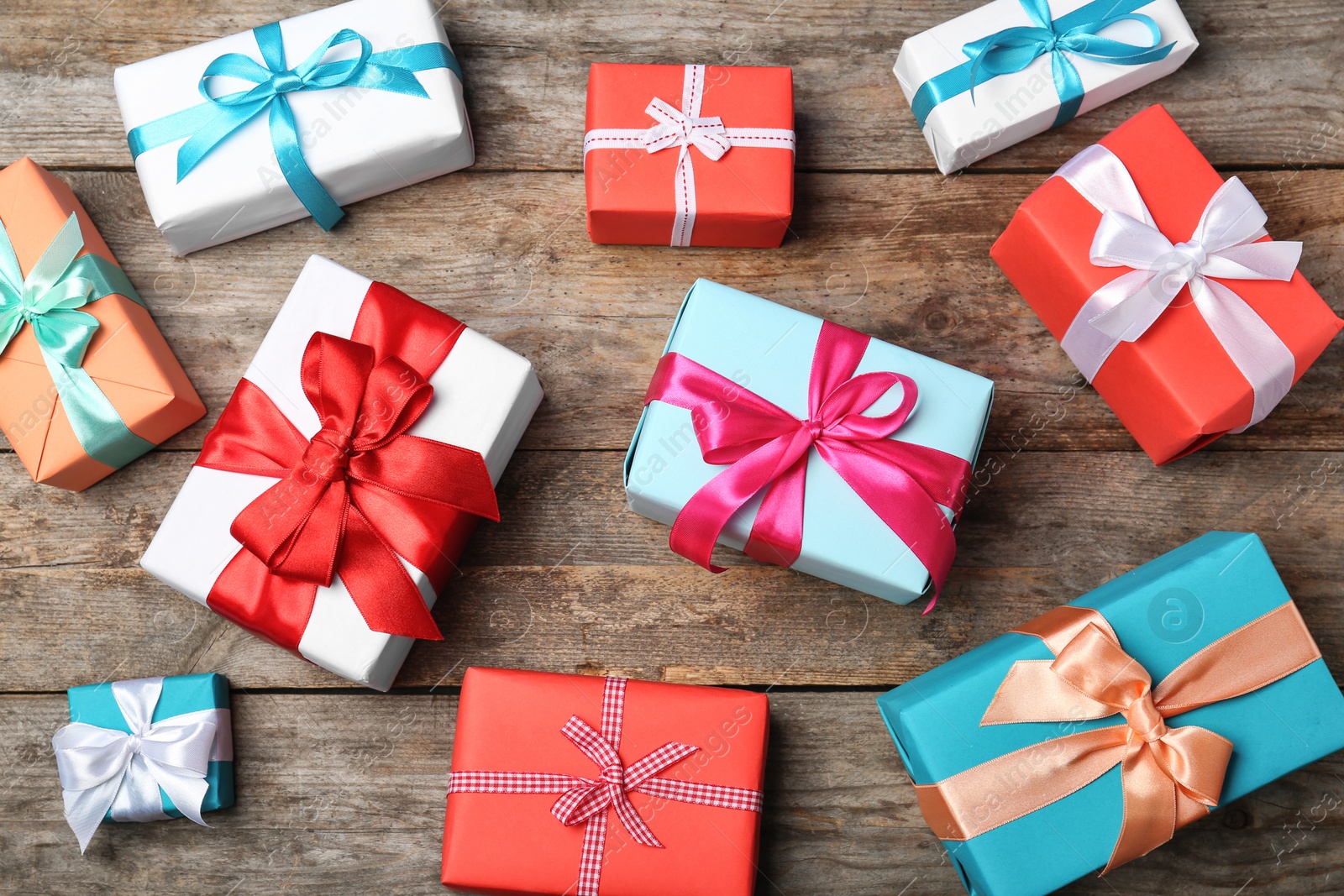 Photo of Flat lay composition with beautiful gift boxes on wooden background