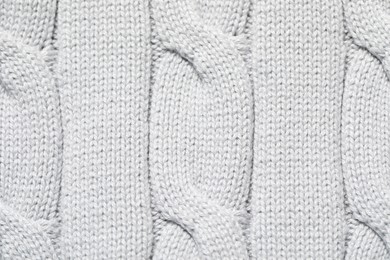 Texture of soft light knitted fabric as background, top view