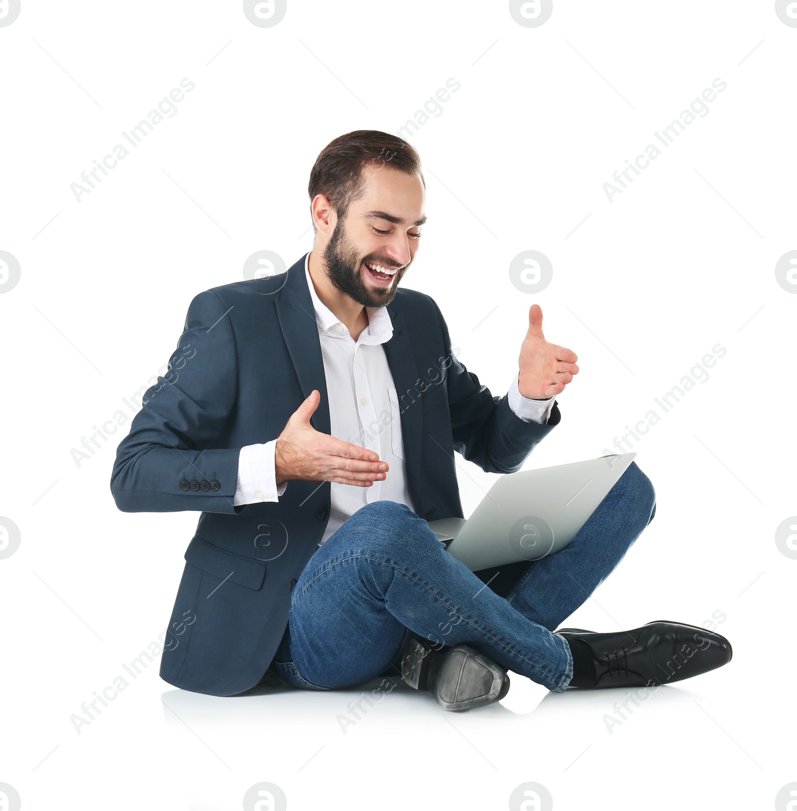 Photo of Emotional businessman in office wear with laptop celebrating victory on white background