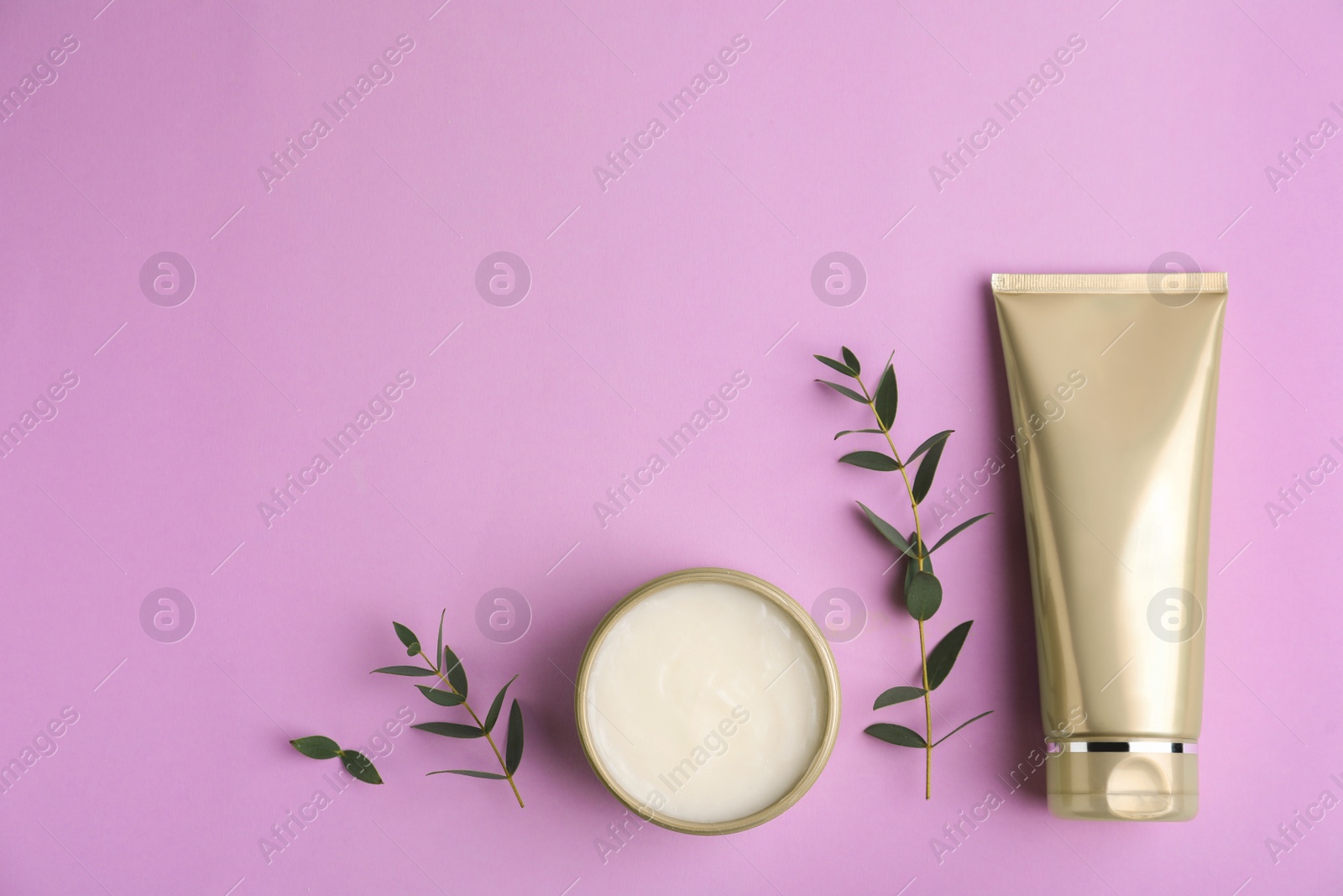 Photo of Flat lay composition with cosmetic products on lilac background. Space for text