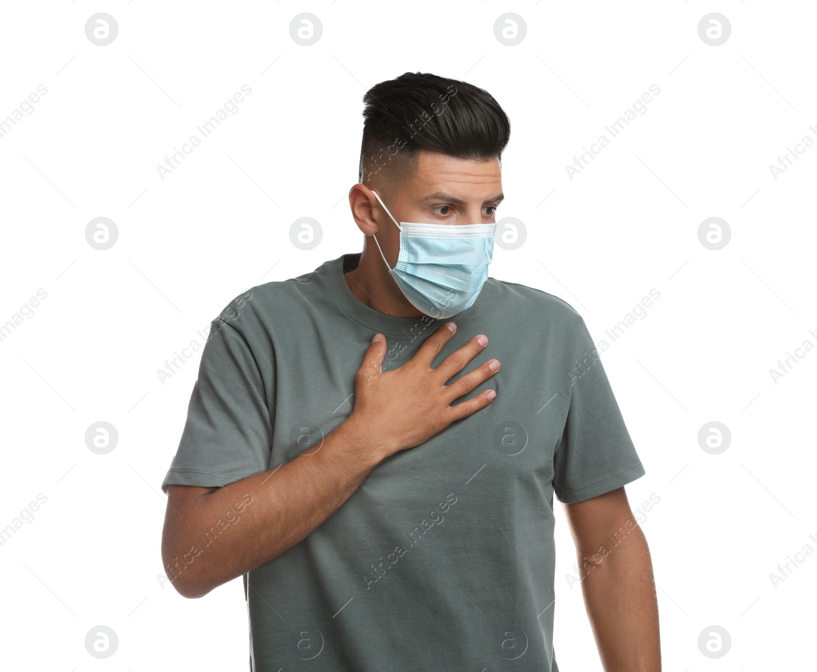 Photo of Man in medical mask suffering from pain during breathing on white background