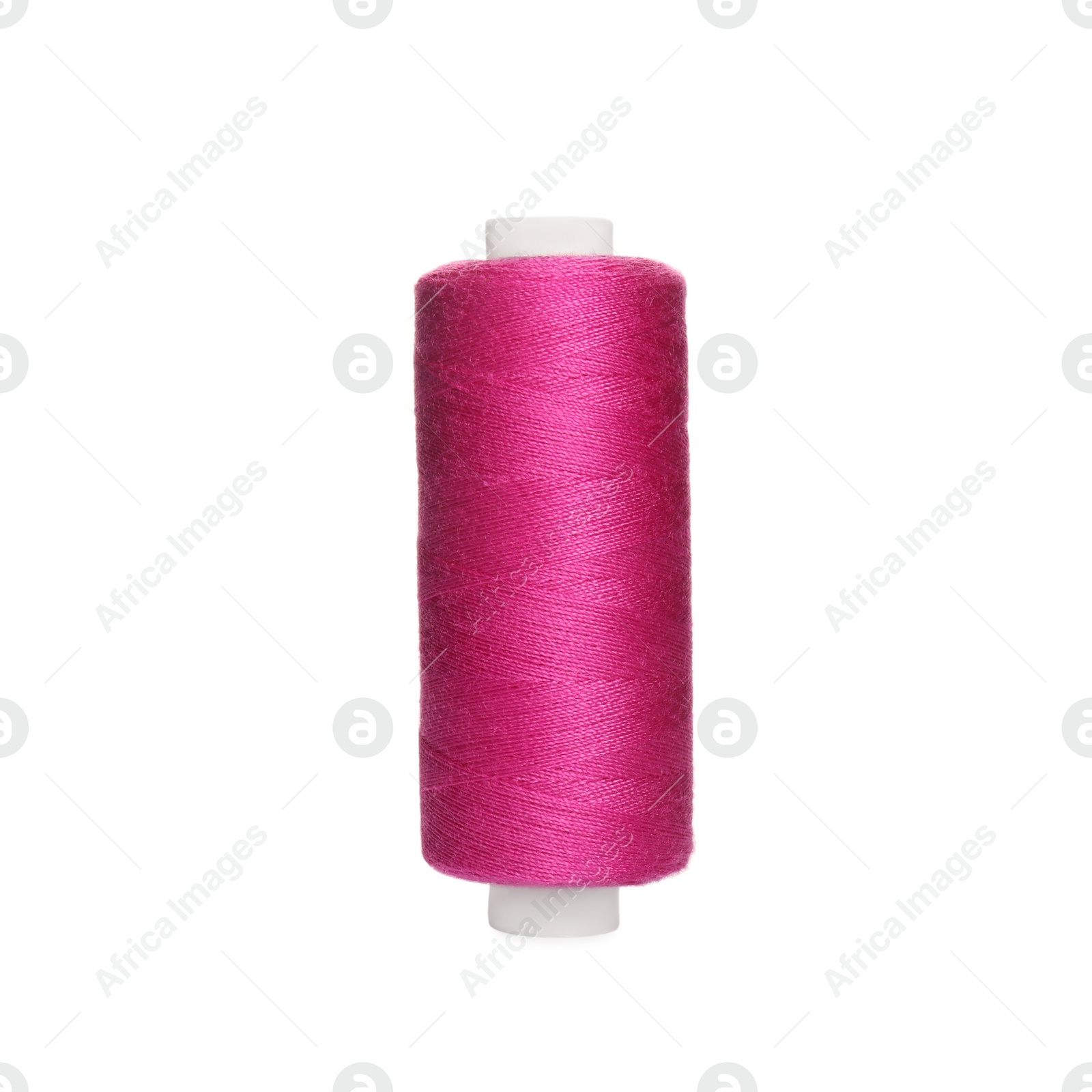 Photo of Spool of bright pink sewing thread isolated on white