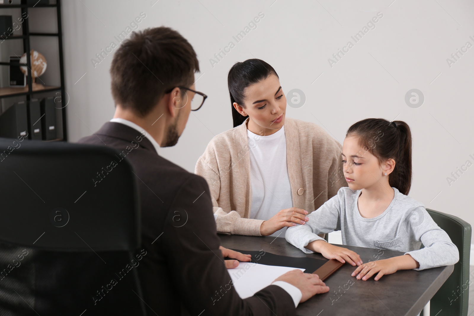 Photo of Mother and daughter having meeting with principal at school