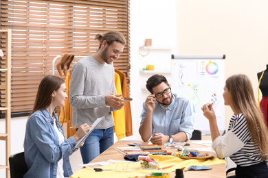 Photo of Fashion designers creating new clothes in studio