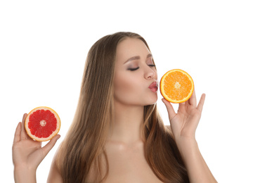 Photo of Young woman with cut orange and grapefruit on white background. Vitamin rich food