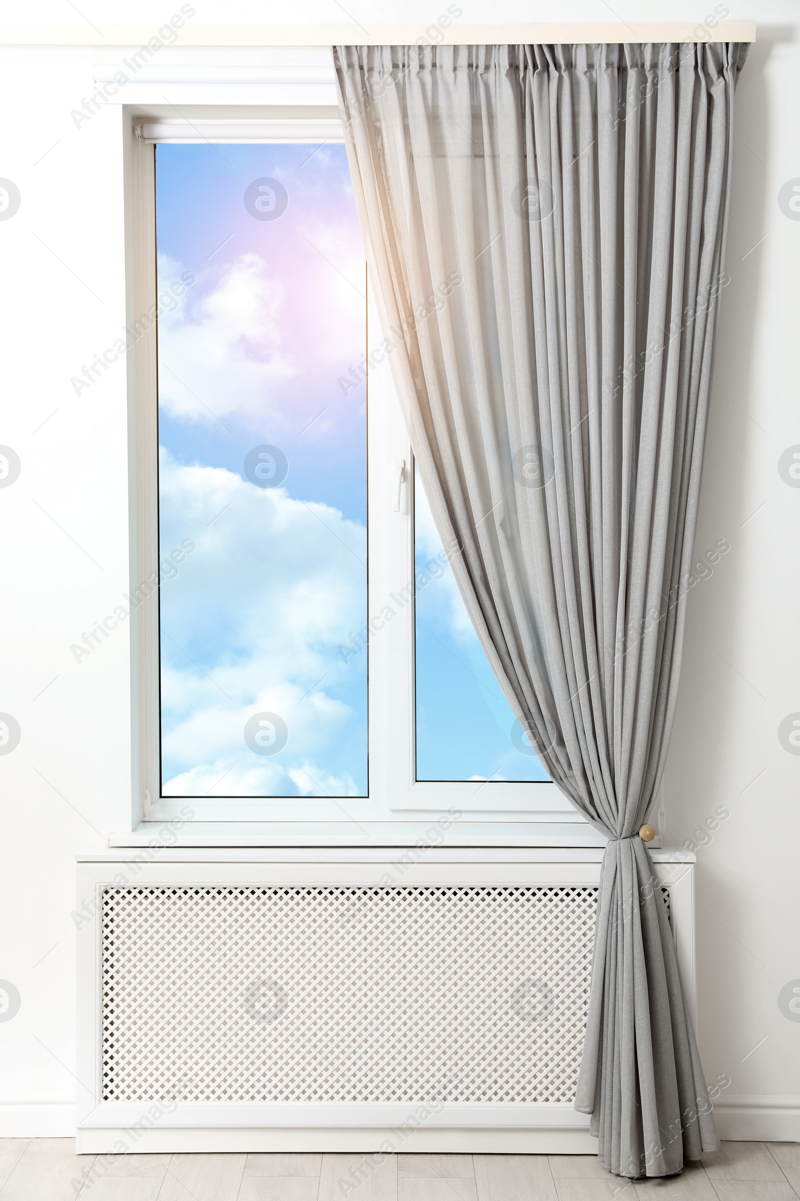 Image of Beautiful view on blue sky with clouds through window in room