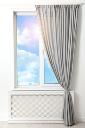 Image of Beautiful view on blue sky with clouds through window in room