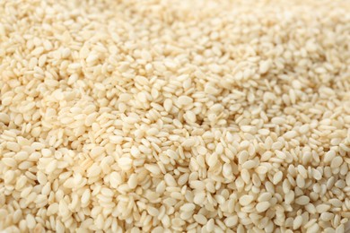 Photo of Pile of white sesame seeds as background, closeup
