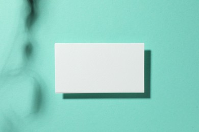 Photo of Empty business card on light blue background, top view. Mockup for design