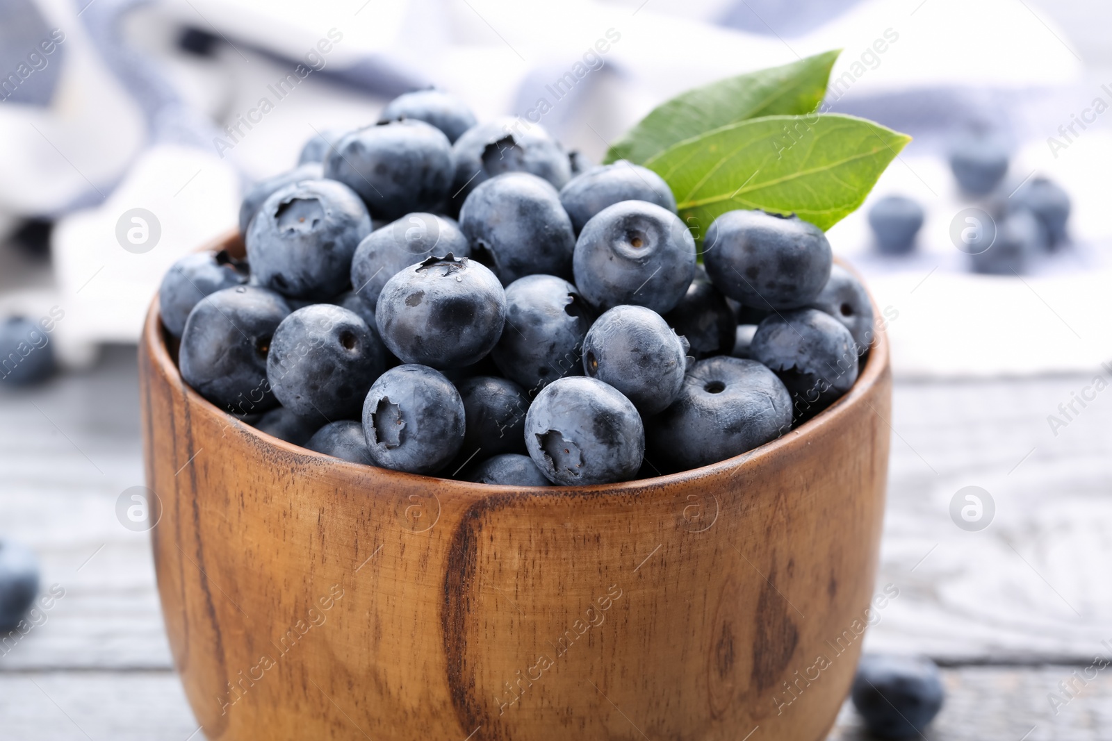 Photo of Tasty fresh blueberries on wooden table, closeup