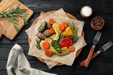 Delicious grilled vegetables served on black wooden table, flat lay