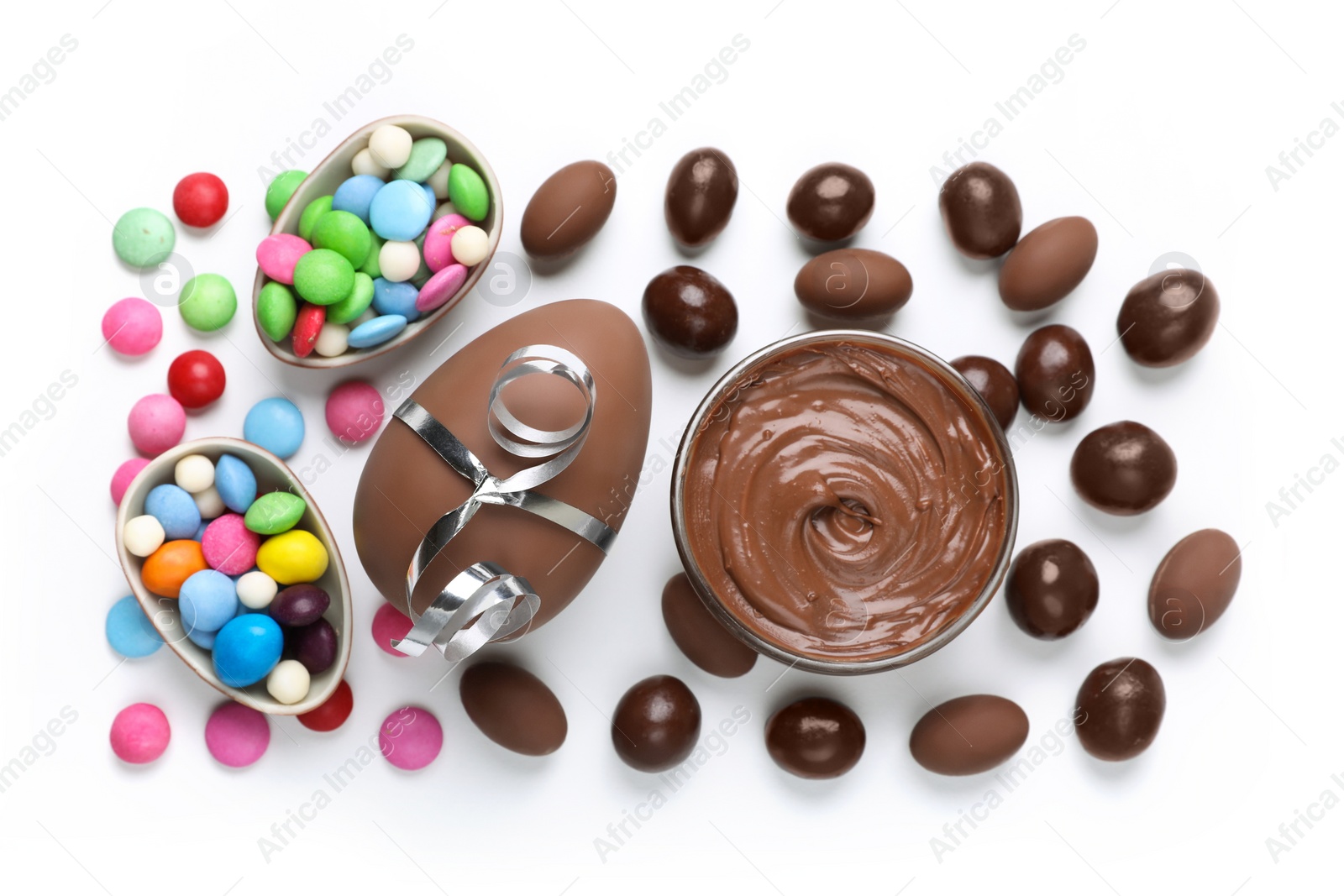 Photo of Flat lay composition with tasty chocolate eggs and candies on white background