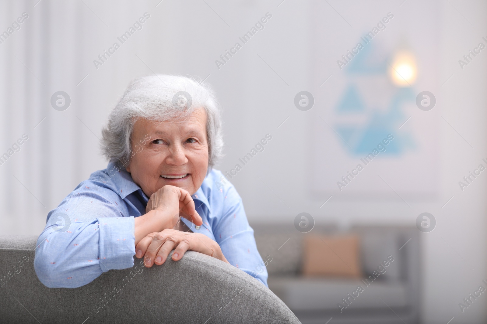 Photo of Portrait of beautiful grandmother in living room