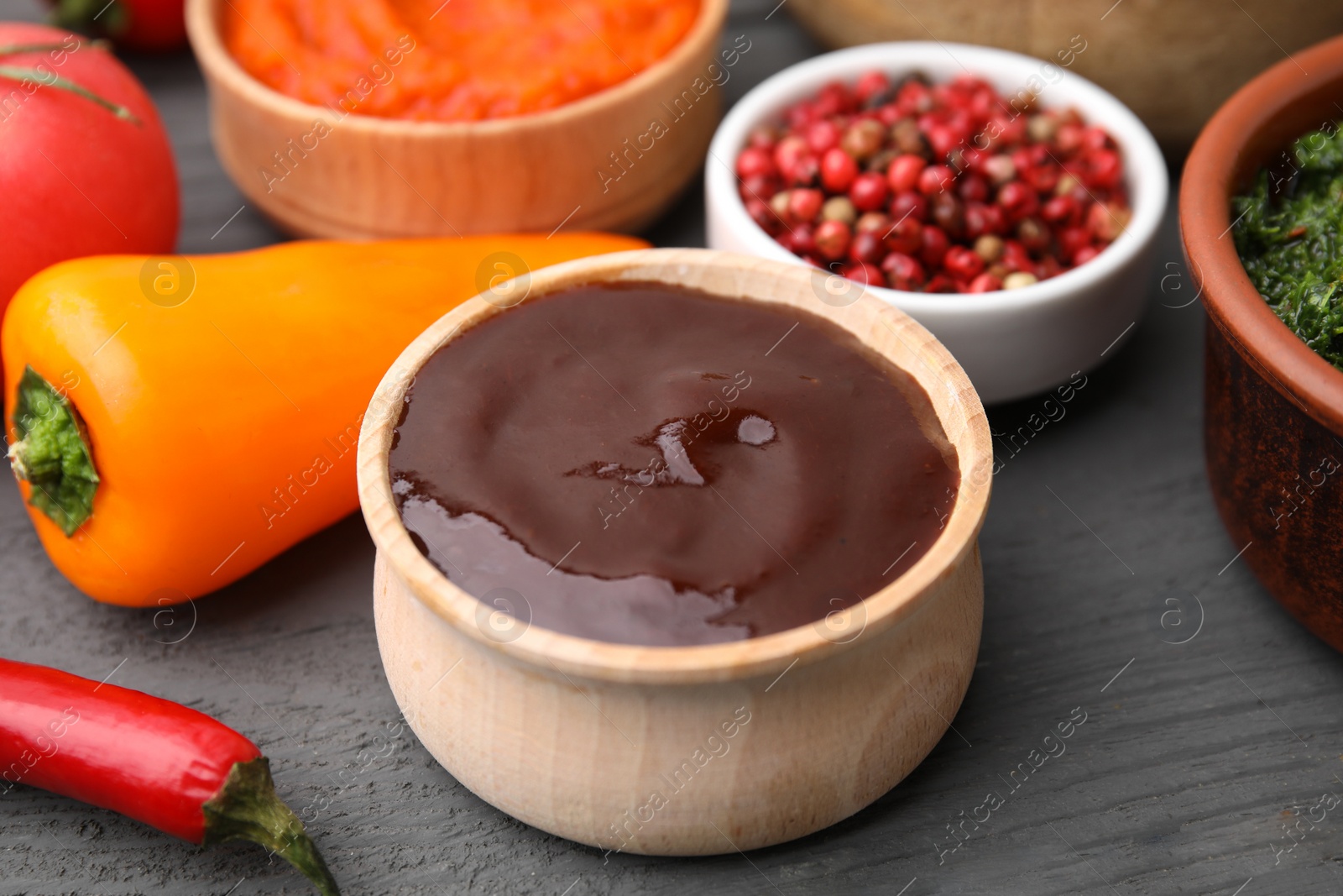 Photo of Fresh marinade and ingredients on grey wooden table, closeup