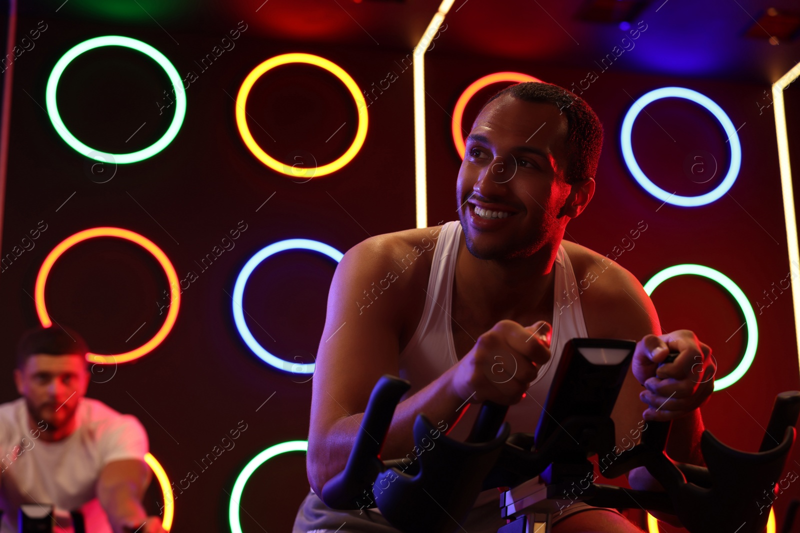 Photo of Group of people training on exercise bikes in fitness club