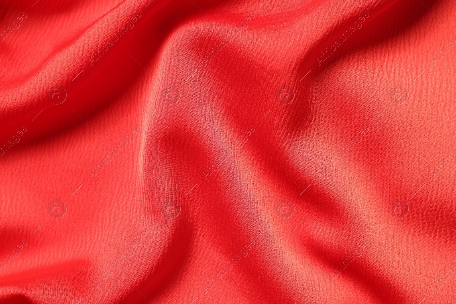 Photo of Texture of red crumpled fabric as background, top view