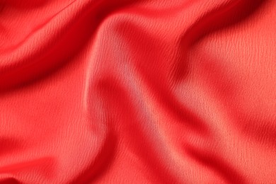 Texture of red crumpled fabric as background, top view