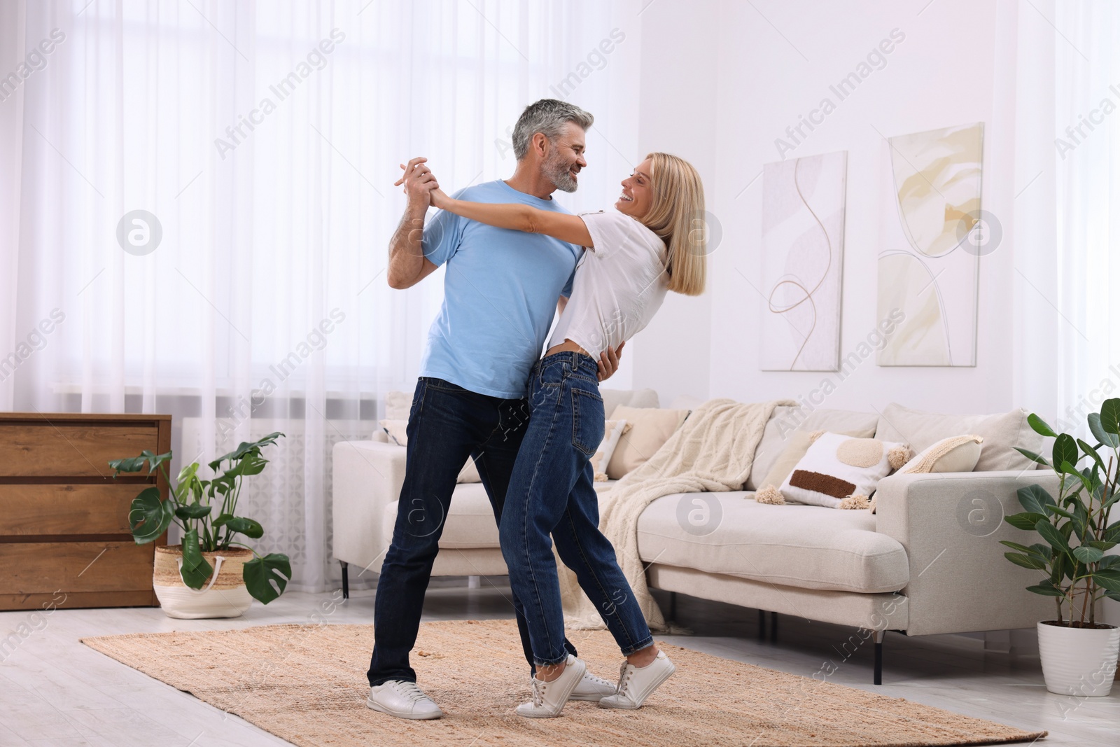 Photo of Happy affectionate couple dancing at home, space for text. Romantic date