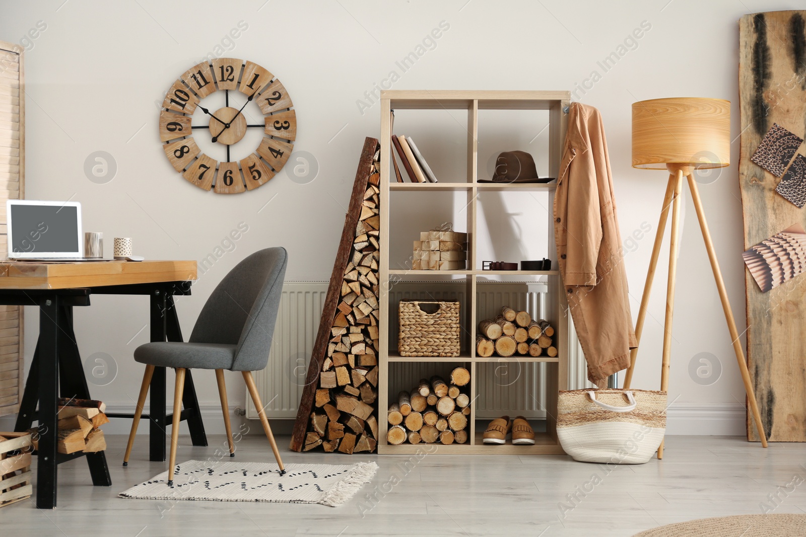 Photo of Stylish room interior with firewood as decorative element