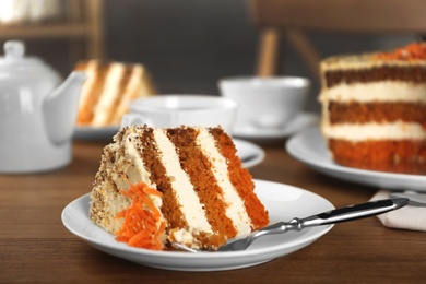 Tasty carrot cake served on wooden table