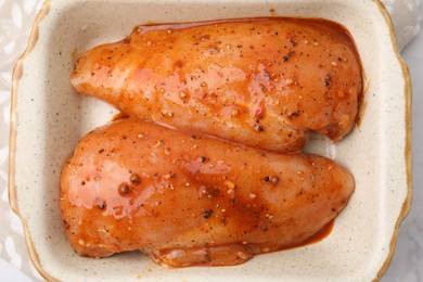 Photo of Raw marinated chicken fillets on table, top view