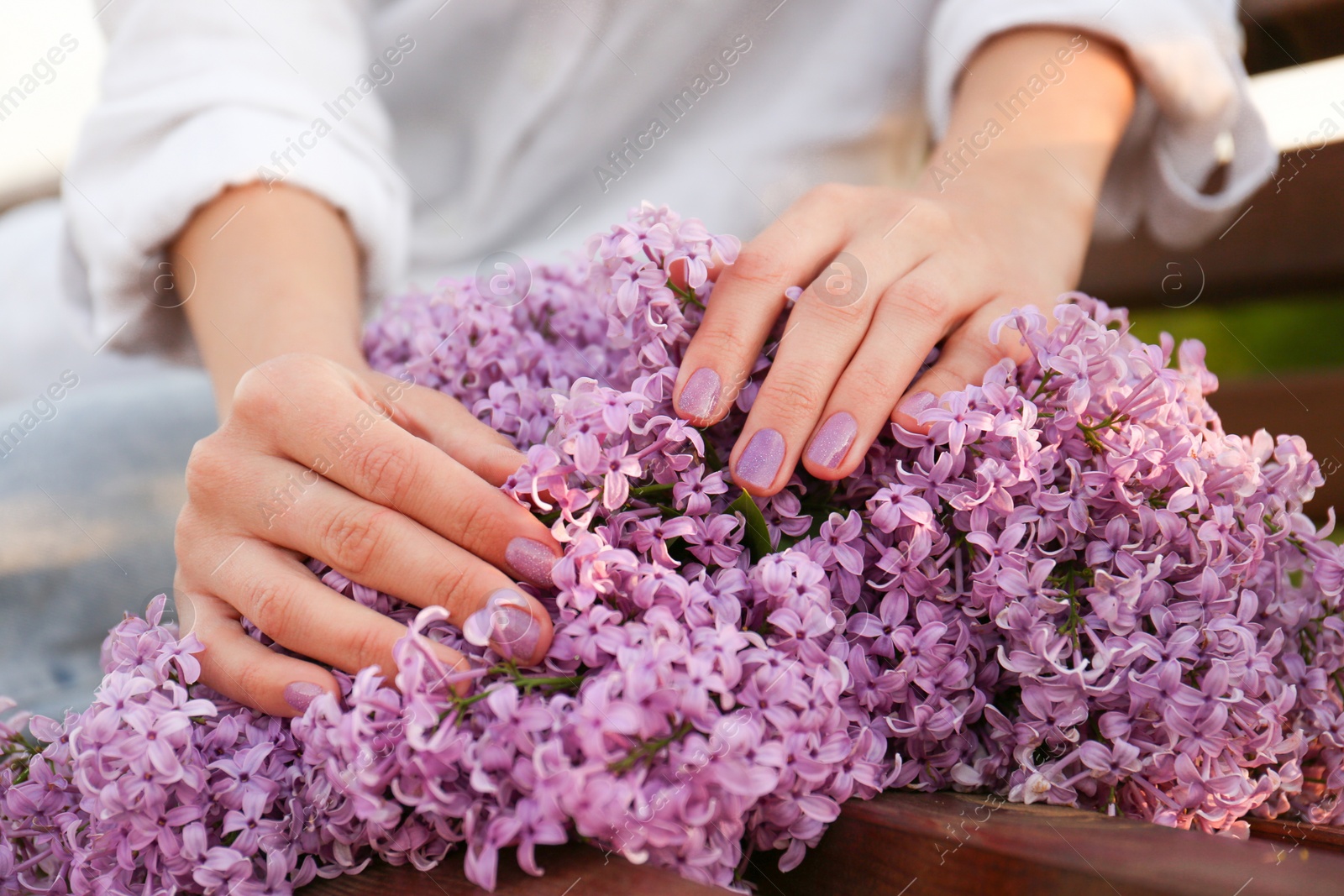 Photo of Woman with bunch of beautiful lilac flowers, closeup