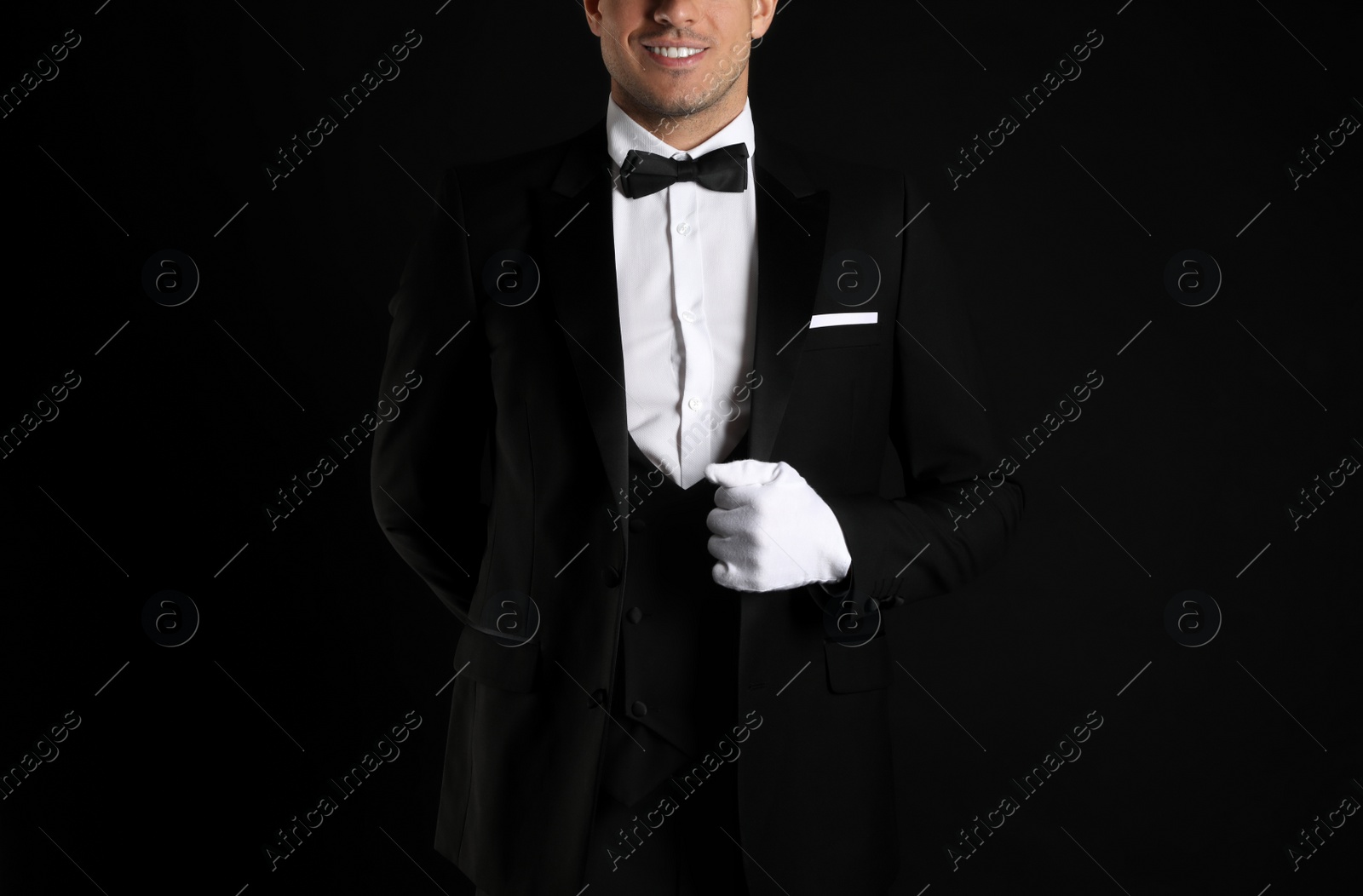 Photo of Butler in elegant uniform on black background, closeup