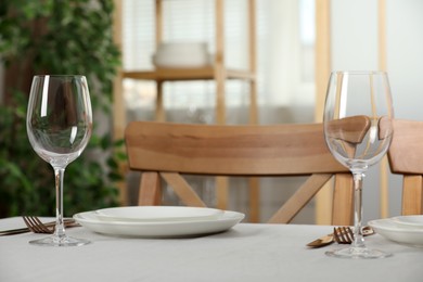 Table setting in dining room. Clean dishware