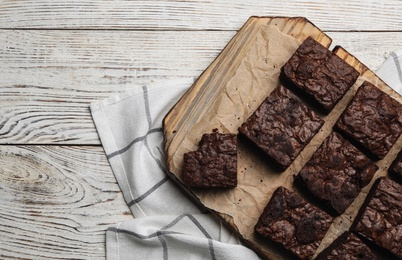 Photo of Flat lay composition with fresh brownies and space for text on wooden background. Delicious chocolate pie