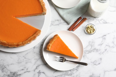 Photo of Flat lay composition with fresh delicious homemade pumpkin pie on marble background