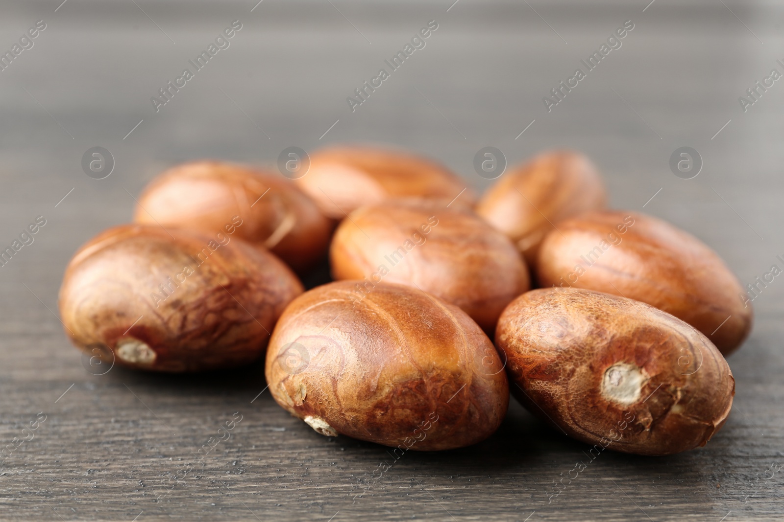 Photo of Many raw jackfruit seeds on wooden table, closeup