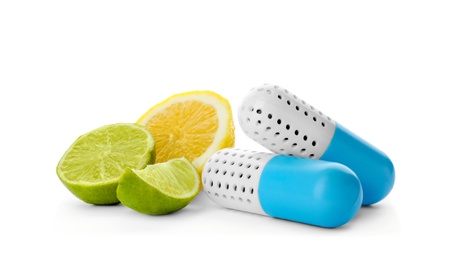 Photo of Capsule shoe fresheners and citrus fruits on white background