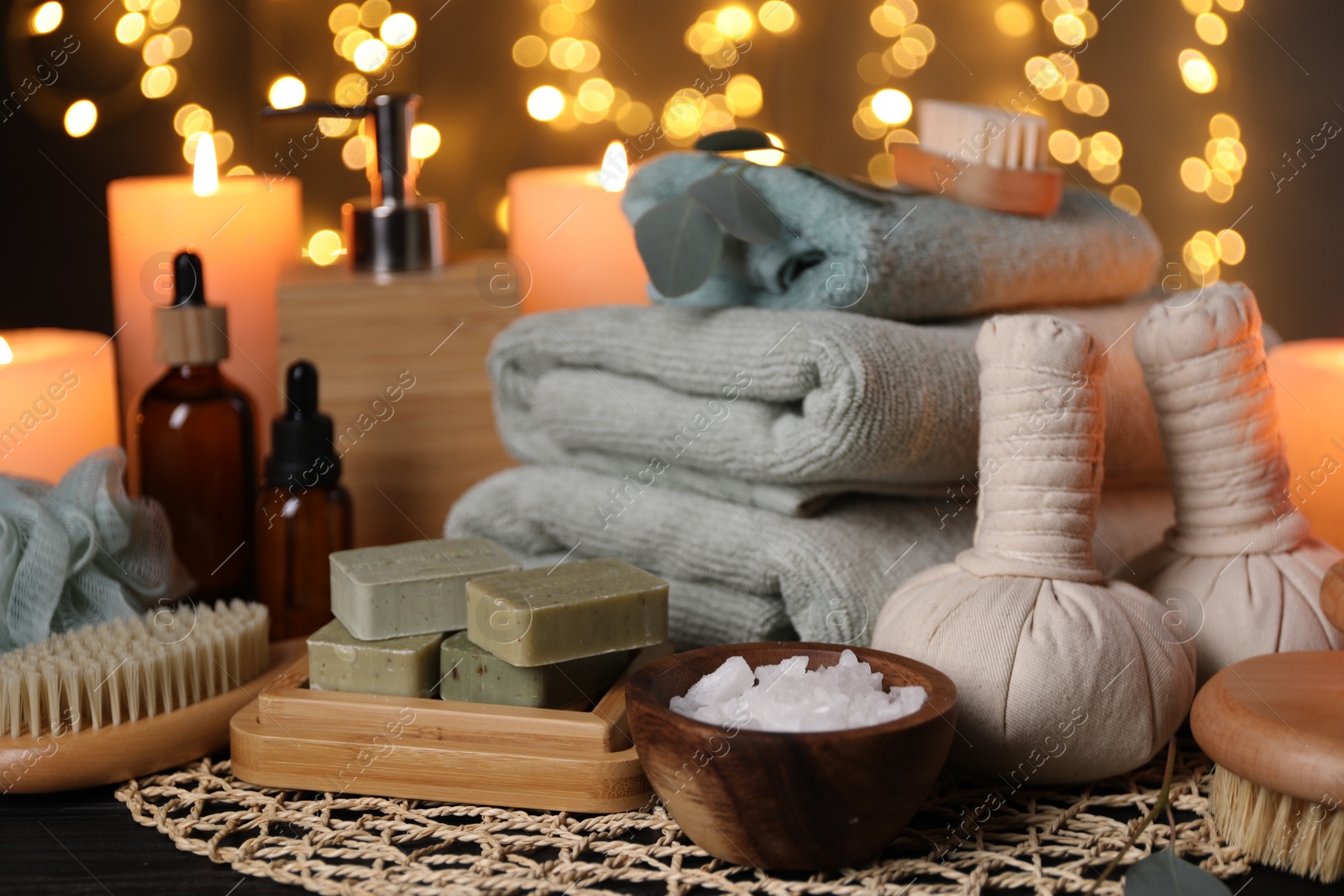 Photo of Beautiful composition with different spa products on table against blurred lights