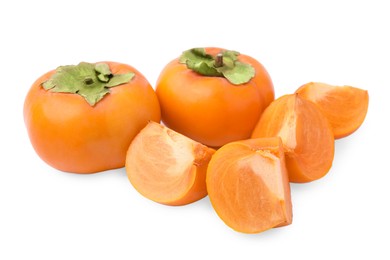 Whole and cut delicious ripe juicy persimmons on white background
