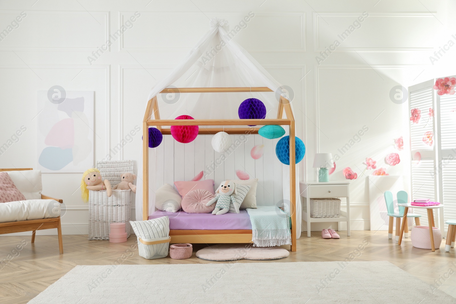 Photo of Stylish room for kid with house bed. Interior design