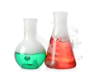 Laboratory flasks with colorful liquids and steam isolated on white. Chemical reaction