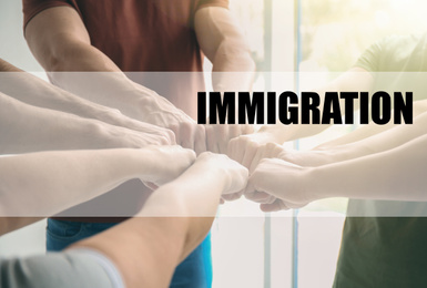 Image of Immigration concept. People putting fists together, closeup view